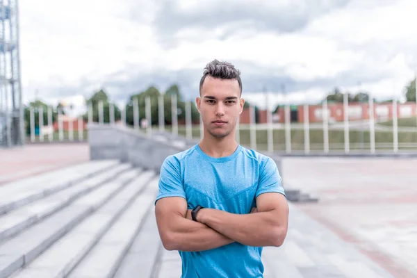 Portrait of handsome, athletic man posing, coach controls exercises, training in summer day in city, active lifestyle, modern fitness workout. Free space for motivation text. — Stock Photo, Image