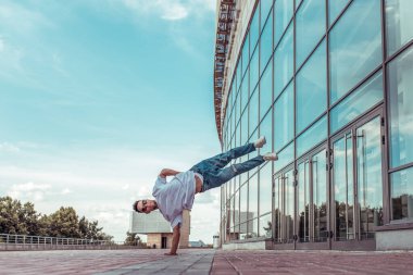 Strong man acrobat dancer, handstand, breakdance dancing, summer city, free space text, hip hop dancer. Youth lifestyle, active trend modern, fitness sport, motivation