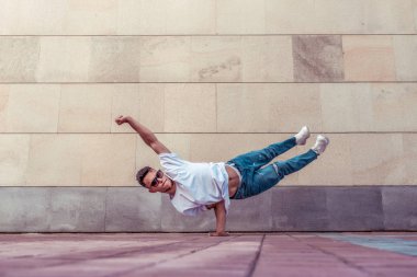 Superman flight, man acrobat dancer, handstand, dancing breakdance, summer city, free space text, hip hop dancer. Youth lifestyle, active, trend modern, fitness sport, positive motivation.