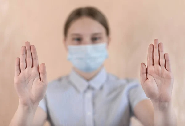 Дівчинка-підліток 14-15 років, одягнена в медичну маску, зосереджена на руках, увага зосереджена на жесті, ретельному вірусі та грипі та захворюваннях, залишатися вдома, зупинити пандемію ковадла коронавірусу 19 — стокове фото