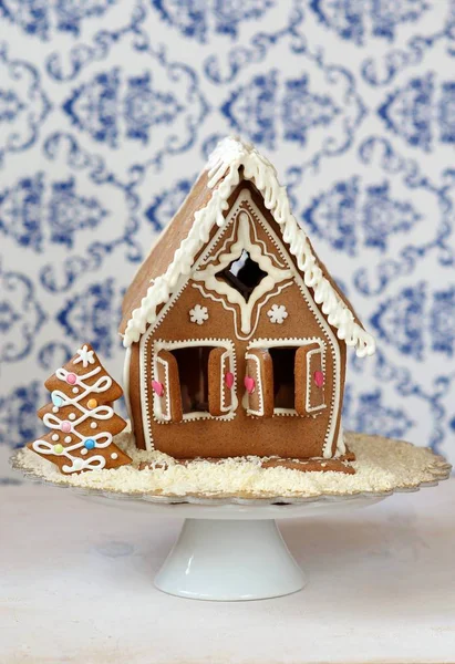 Traditional gingerbread house with gingerbread christmas tree