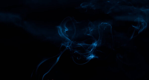 Abstract blue smoke texture against back background.