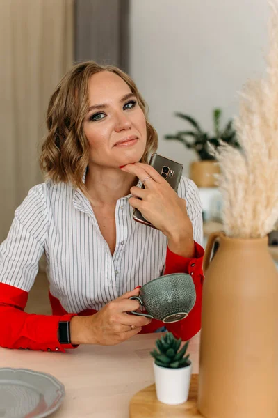 Mladá Krásná Dívka Sedí Stolu Jasné Kuchyni Šťastně Usměje Svůj — Stock fotografie