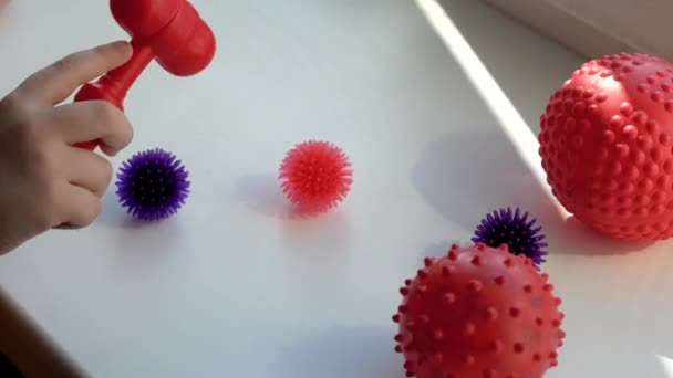 Boy Taps Toy Hammer Red Blue Balls Spikes Virus Windowsill — Stock Video