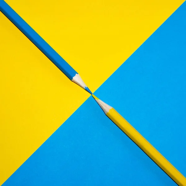 Yellow, blue and green pencils. Concept of blending primary colours. Minimal Aesthetic.