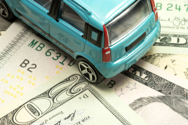 A car and many dollar banknotes