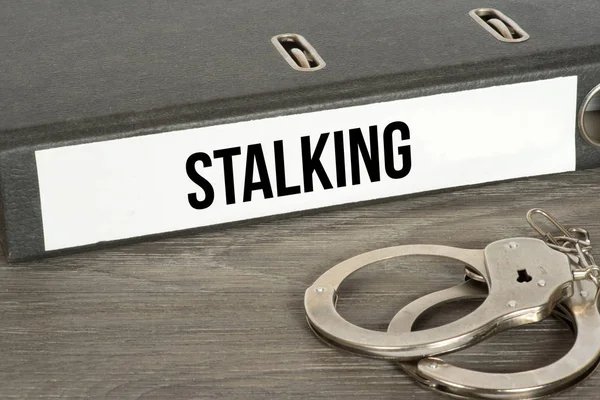 Handcuffs Documents Folder Stalking Inscription Wooden Tabletop — Stock Photo, Image