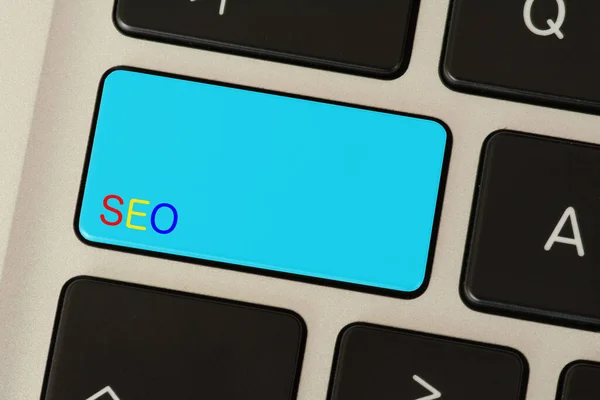 A computer and button for SEO Search Engine Optimization