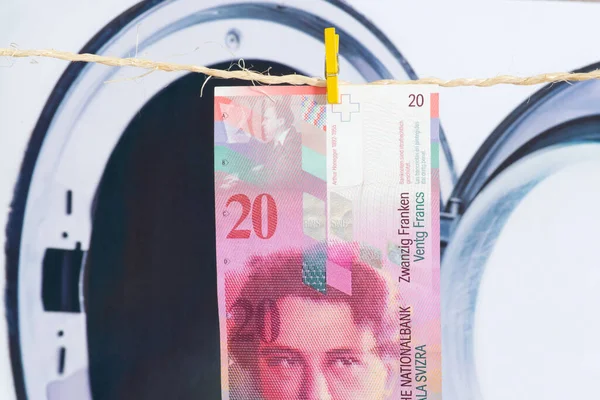 Money Swiss Francs, washing machine and money laundering