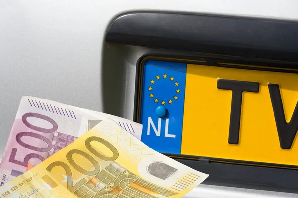 A car with Dutch registration and euro banknotes