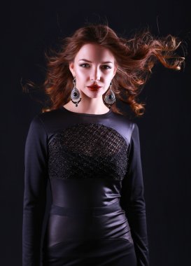 Siyah elbiseli, akşam makyajlı güzel bir kadın.