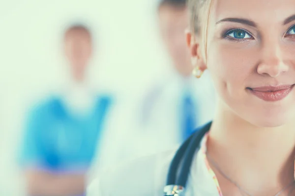 Attractive female doctor in front of medical group — Stock Photo, Image