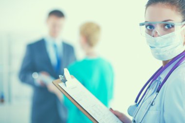 Kadın doktor hastanede dosyayla bekliyor.