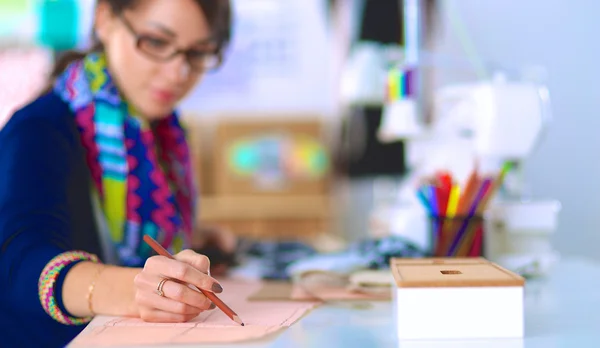 Dressmaker designing clothes pattern on paper — Stock Photo, Image