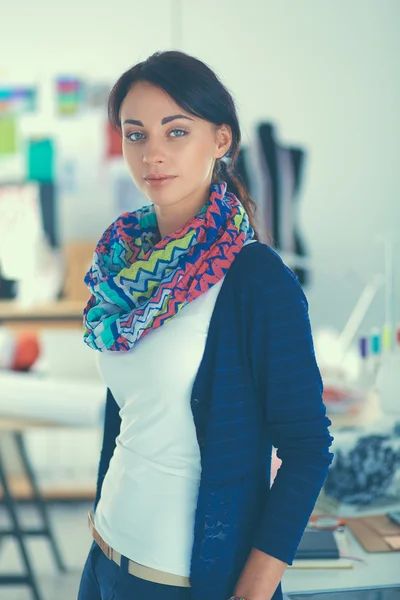 Beautiful fashion woman designer standing in studio