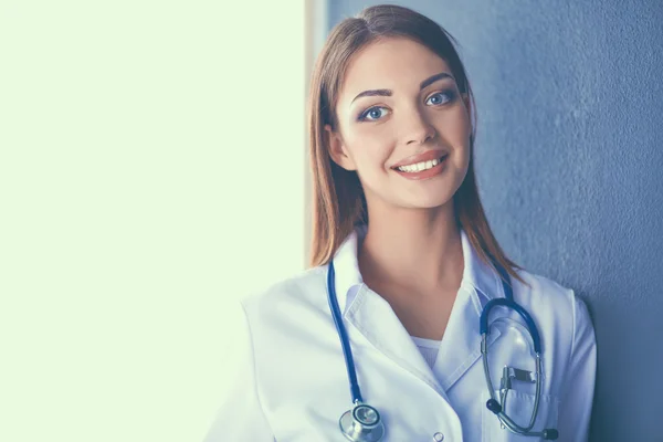 Doctor woman with stethoscope isolated on grey background — Stock Photo, Image