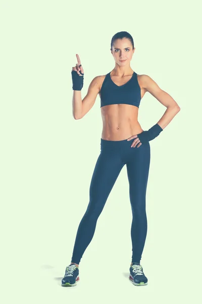 Musculosa joven posando en ropa deportiva sobre fondo blanco —  Fotos de Stock