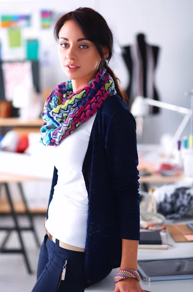 Beautiful fashion woman designer standing in studio