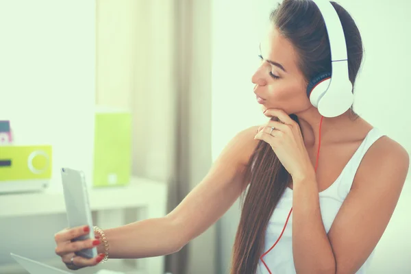 Joven hermosa mujer en la cama escuchando música —  Fotos de Stock