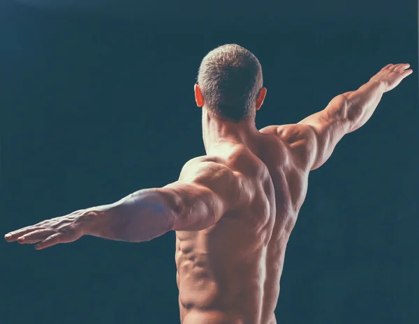 Hombre joven muscular sano. aislados sobre fondo negro — Stockfoto