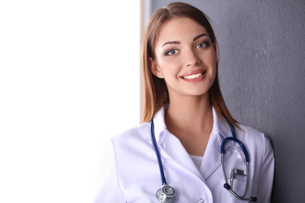 Doctor woman with stethoscope isolated on grey background — Stock Photo, Image