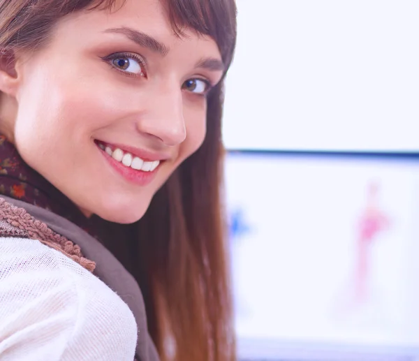 Portrait of attractive female fashion designer sitting at office desk — Stock Photo, Image