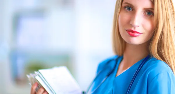 Portrait of woman doctor with folder at hospital corridor — Stock Photo, Image