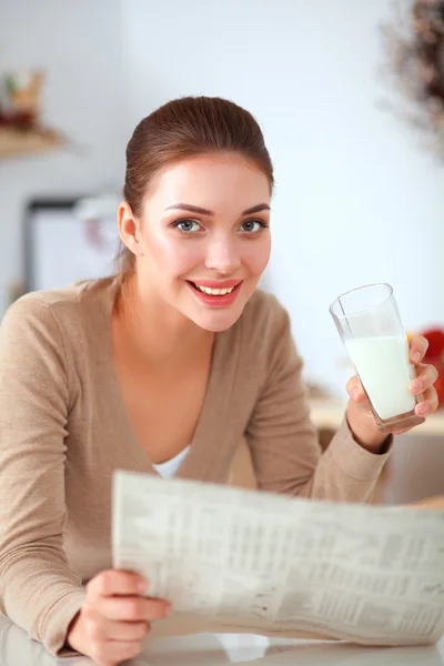 Young smilling woman standing in her kitchen — Stock Photo, Image