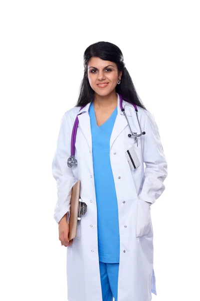 Doctor woman with stethoscope standing near wall Stock Picture