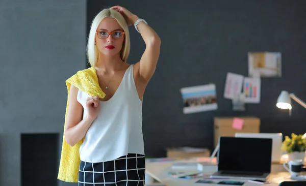 Young fashion designer woman working in studio