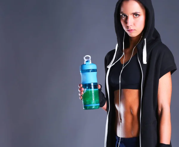 Girl with bottle in hands after sport — Stock Photo, Image