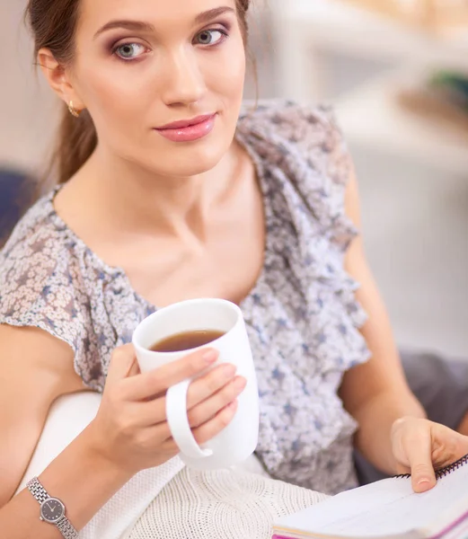 Attractive businesswoman sitting on desk in the office — Stock Photo, Image