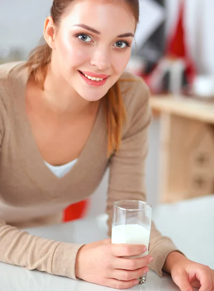 Young smilling woman standing in her kitchen — Stock Photo, Image