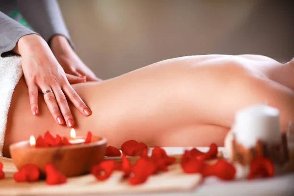 Beautiful young woman getting spa massage, lying — Stock Photo, Image