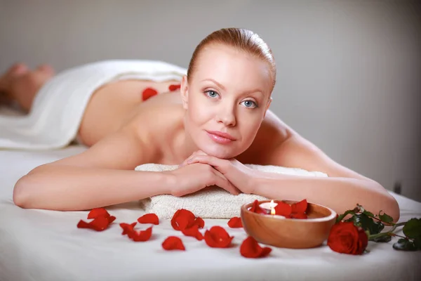 Beautiful young woman getting spa massage, lying — Stock Photo, Image