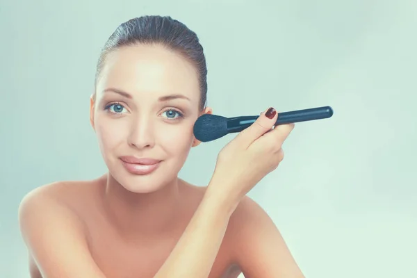 Portrait of attractive young adult woman with make-up brush — Stock Photo, Image