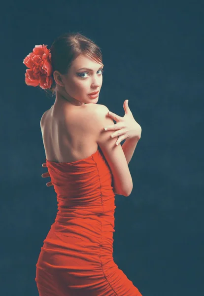 Young woman in red dress, isolated on black background — Stock Photo, Image