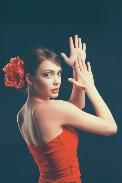 Young woman in red dress, isolated on black background — Stock Photo, Image