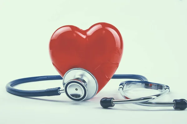 Red heart and a stethoscope on desk — Stock Photo, Image