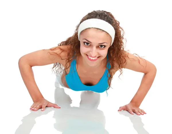 Jonge vrouw doen push-ups op een mat — Stockfoto