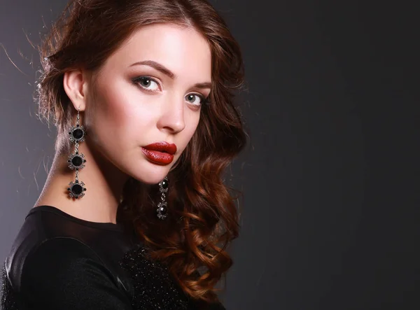 Beautiful woman with evening make-up in black dress — Stock Photo, Image