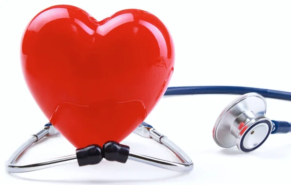 Red heart and a stethoscope on desk — Stock Photo, Image