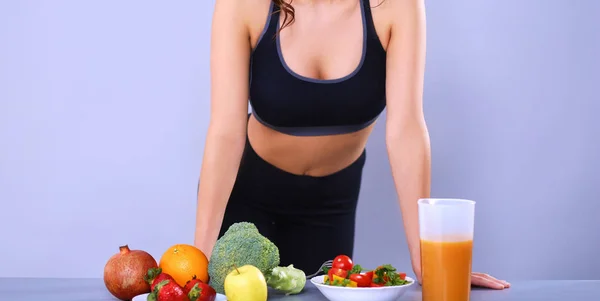 Молодая и красивая женщина, стоящая у стола с овощами — стоковое фото