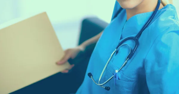 Portrait of a happy young doctor sitting on the sofa with folder — Stock Photo, Image