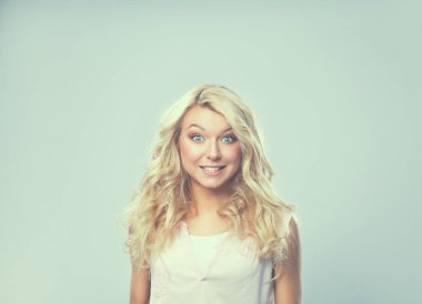 Gri arka planda soyutlanmış genç, duygusal bir kadın.