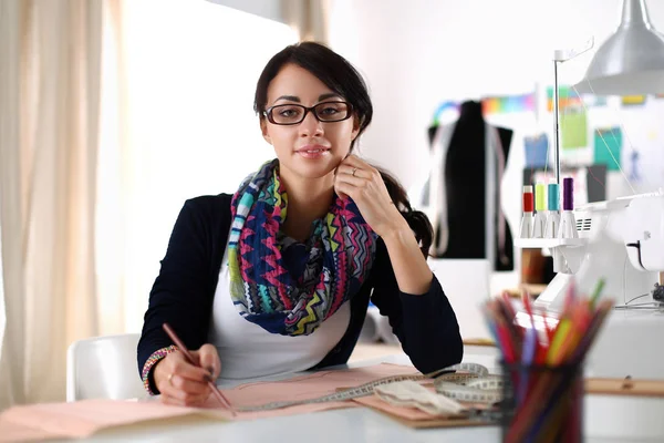Dressmaker kvinna designa kläder mönster på papper — Stockfoto