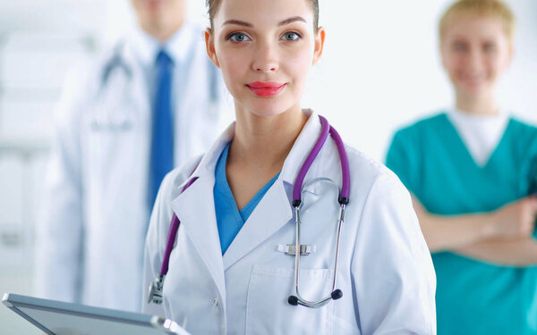 Woman doctor standing with folder at hospital