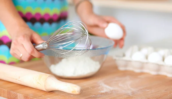 Woman is making cakes in the kitchen