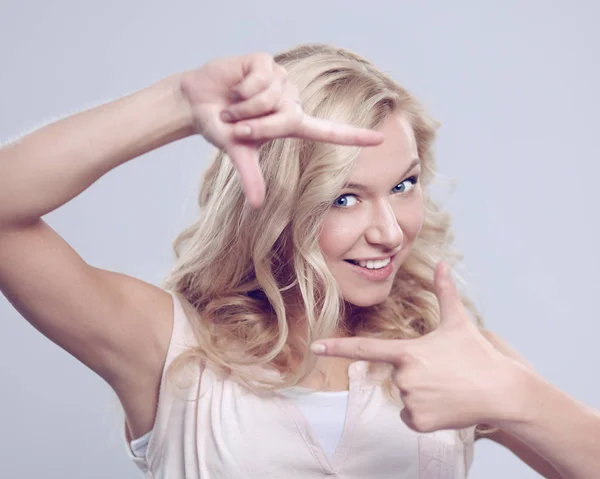 Young woman creating a frame with fingers — Stock Photo, Image