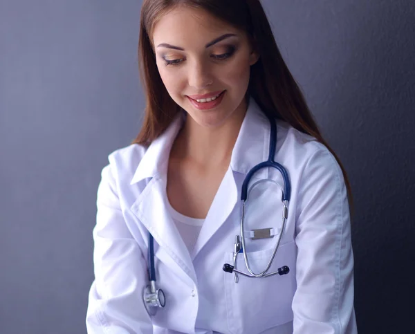 Female doctor working sitting on gray  background — Stock Photo, Image